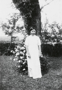 A young woman, named as Yu Lan, in a garden