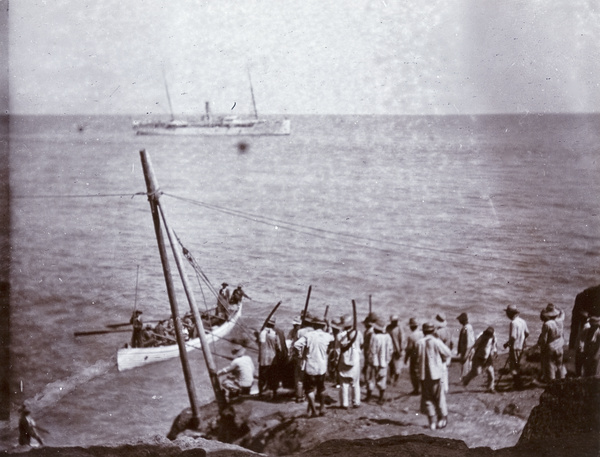 Lighhouse construction workers and rowing boat