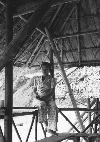 Lucy Shirazee on the balcony of a beach hut, Hong Kong