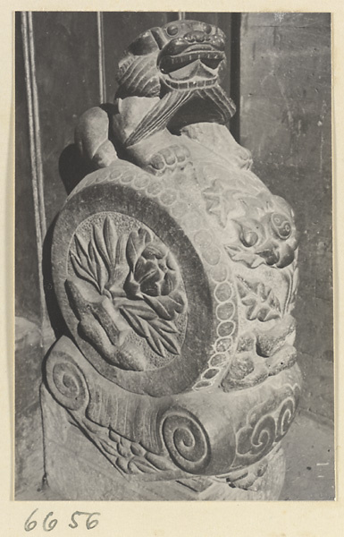 Carved door stone with floral and ling zhi fungus motifs and animal finial