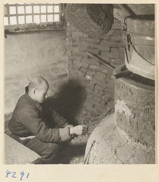 Man at work in a tofu-making shop