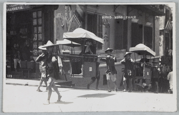 Sedan chairs passing a tobacconist, Hong Kong