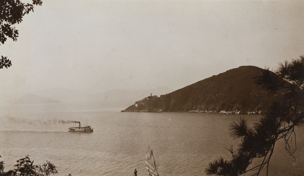 Green Island lighthouse, and a ferry boat in Sulphur Channel, Hong Kong