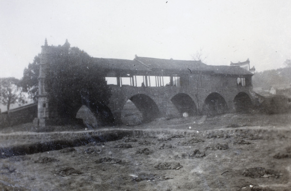 A covered bridge on the Wufungpu road, south of Shaoyang, with animal fleeces