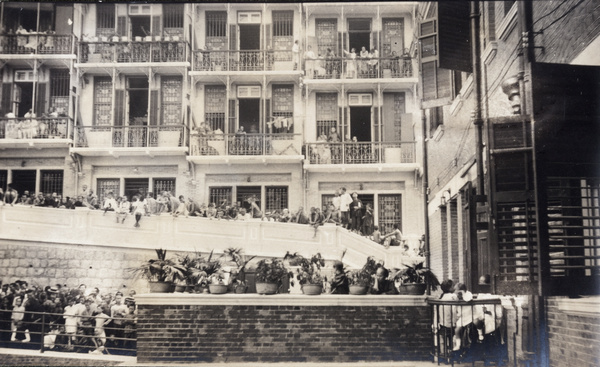 People watching at event in the square by the Chinese YMCA, Hong Kong