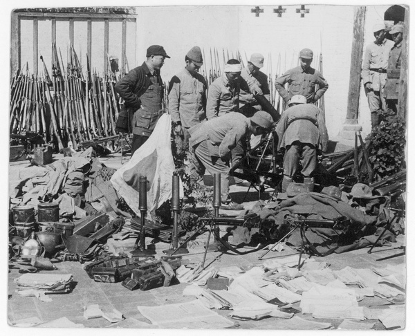 Chinese and Japanese soldiers, with weapons, uniforms, documents and a flag captured from the Japanese