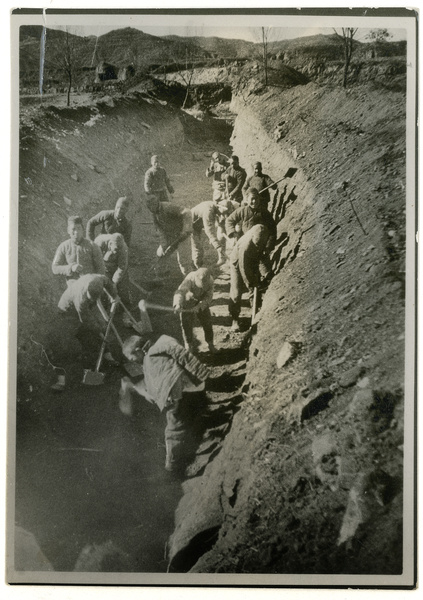 Men digging a wide trench