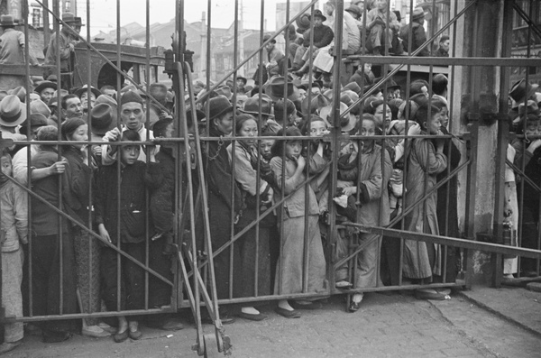 Refugees in front of the closed gates to the French Concession area, Shanghai