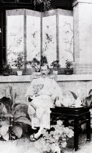 J.B. Affleck (British Consular Service), wearing a Japanese kimono and geta, with bonsai, Beijing (北京)