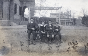 Bill, Fred, Maggie, Harry and Dick Hutchinson on a bench in the garden of 35 Tongshan Road, Hongkew, Shanghai