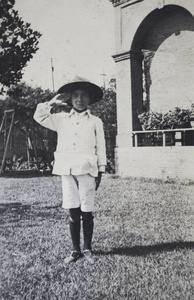 Fred Hutchinson wearing a SVC hat and saluting in the garden, 35 Tongshan Road, Hongkou, Shanghai