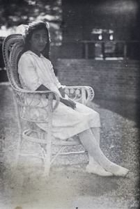 Maggie Hutchinson sitting on a wicker garden chair, 35 Tongshan Road, Hongkou, Shanghai
