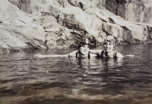 Margie and Sarah Hutchinson wearing stylish bathing caps at an open-air swimming pool, Moganshan