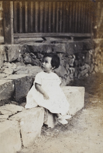 Bea Hutchinson sitting on the steps of a summer house, Moganshan