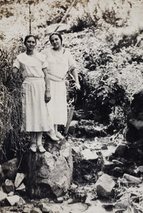 Sarah and Margie Hutchinson standing by a hill stream, Moganshan