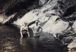 Margie and Sarah Hutchinson, wearing bathing costumes and caps, in an open-air swimming pool, Moganshan