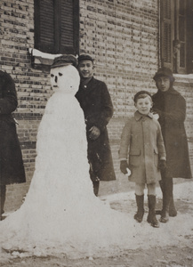 Dick and Maggie Hutchinson making a snowman with neighbouring boy, 35 Tongshan Road, Hongkou, Shanghai