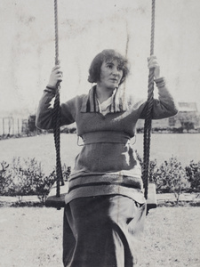 Mrs Koskey wearing a hand knitted sweater sitting on a garden swing, 35 Tongshan Road, Hongkou, Shanghai