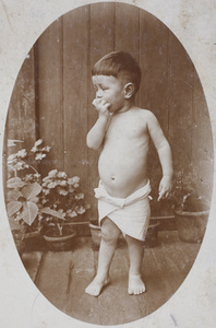 Unidentified toddler wearing a cloth nappy