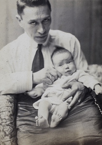 Unidentified man holding a young baby