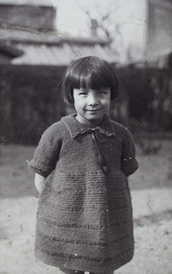 Miss Oliveira wearing a hand knitted dress, in the garden, 35 Tongshan Road, Hongkou, Shanghai