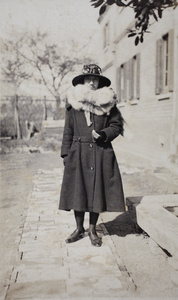 Maggie Hutchinson wearing a winter coat, fox fur stole and wide-brim hat, Hongkou, Shanghai