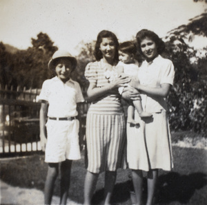 Jim and Bea Hutchinson with an unidentified woman and child, Hong Kong