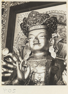 Detail of a statue of a multi-armed Bodhisattva showing head, crown, and arms at Wan shou si