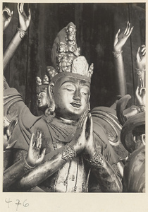 Detail of a statue of a multi-armed, multi-headed Bodhisattva showing head and arms at Fa yuan si