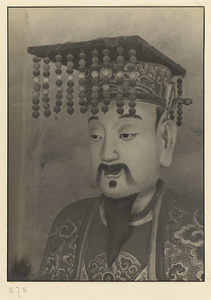 Interior of Wan shan dian showing shrine figure wearing a mian liu hat