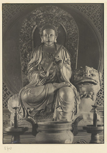 Interior of Wan shan dian showing altar with shrine figure seated on a carved animal