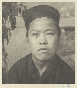 Novice Daoist priest wearing a cap at Bai yun guan