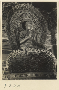Temple interior at Jie tai si showing a statue of Buddha on a lotus throne