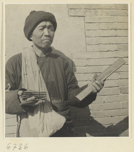 Itinerant story teller holding wooden castanets