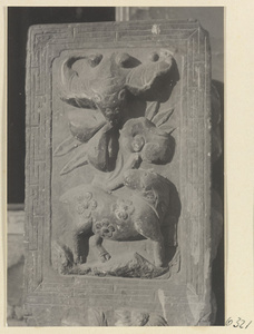 Carved door stone with bat and animal motifs