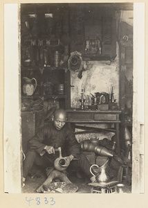 Coppersmith making a pitcher in a workshop