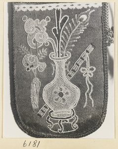 Detail of embroidered pipe bag showing vase with ling zhi fungus and peacock feather, and flutes