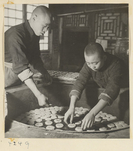 Bakers arranging moon cakes in a bakery