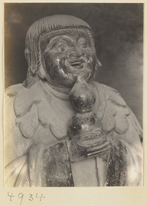Detail of a clay figure of the Daoist immortal Li Tieguai holding a gourd on Hua Mountain