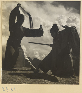 Daoist priests with a sword and a yak-tail fly whisk performing a ceremonial dance on East Peak of Hua Mountain