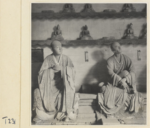 Interior of a temple building at Ling yan si showing statues of Luohans and figurines of Buddhas