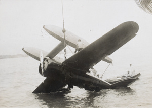 Hoisting Charles Lindbergh’s plane ‘Sirius’ from the Yangtze River onto HMS Hermes, Hankow (Wuhan)