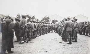 Nationalist soldiers assembling in a parade ground with flags