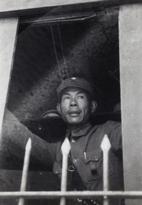 Chinese Nationalist soldier looking out from a window, Shanghai, 1937