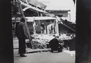Men among debris in an upper storey of the Palace Hotel, Shanghai, after the bombing of 14 August 1937