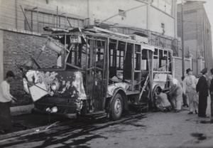 Mechanics attend to a bomb damaged tram, Markham Road, Shanghai, August 1937