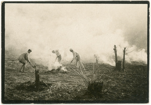 Soldiers attending to bonfires in a field