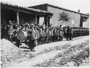 Parade of soldiers with a band welcoming Michael Lindsay (林迈可) and George E. Taylor to General Lu Zhengcao (呂正操)'s headquarters, 1938