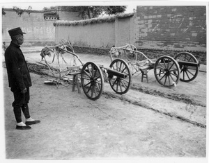 A soldier, with old artillery from early warlord civil wars, Central Hebei province, Spring 1938