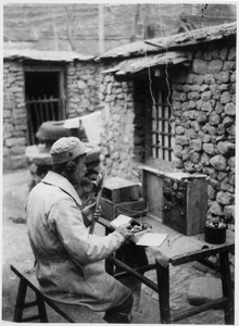 Liang Ji (梁骥), the radio station chief, testing a newly installed transmitter, Jinchaji, 1943